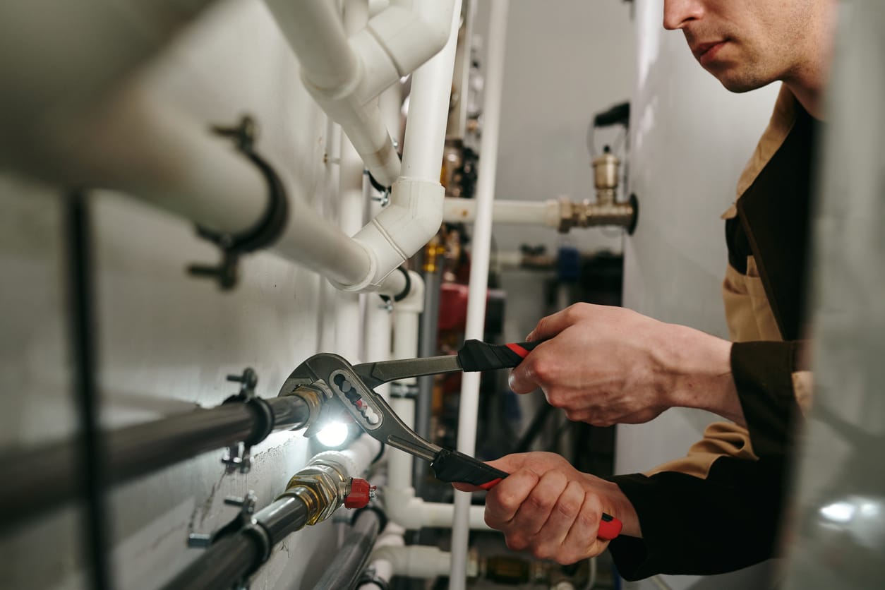 Plumbers maintaining commercial plumbing pipes in Westminster