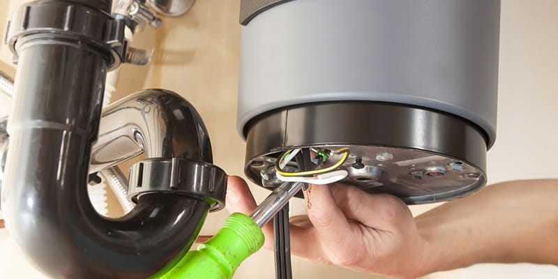 Technician repairing the heating element of a water heater in Westminster