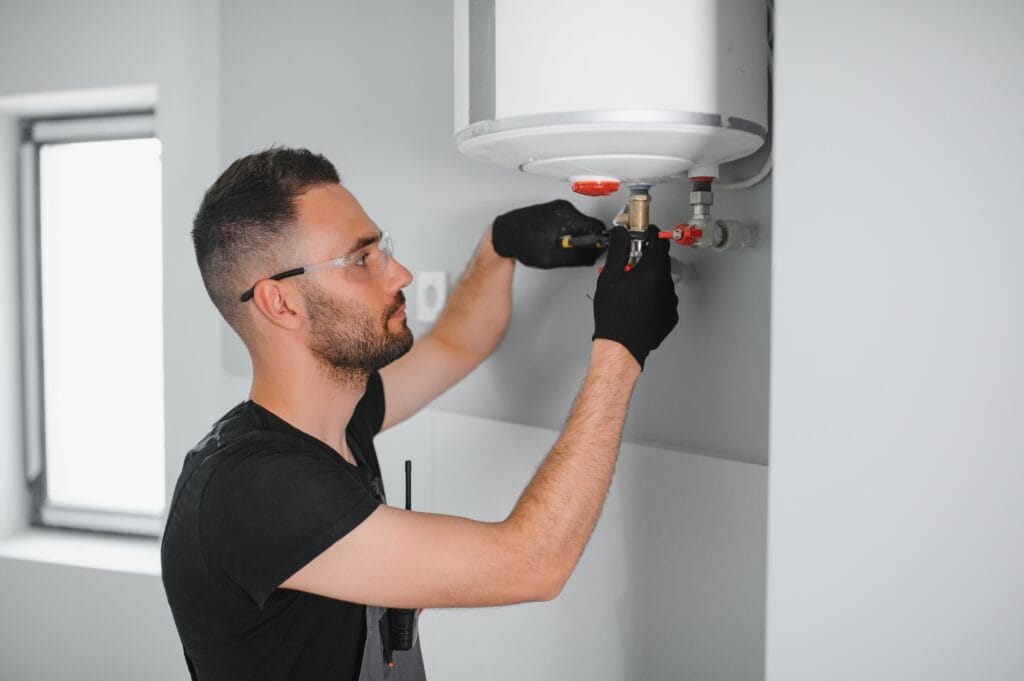 Technician performing water heater maintenance in Westminster